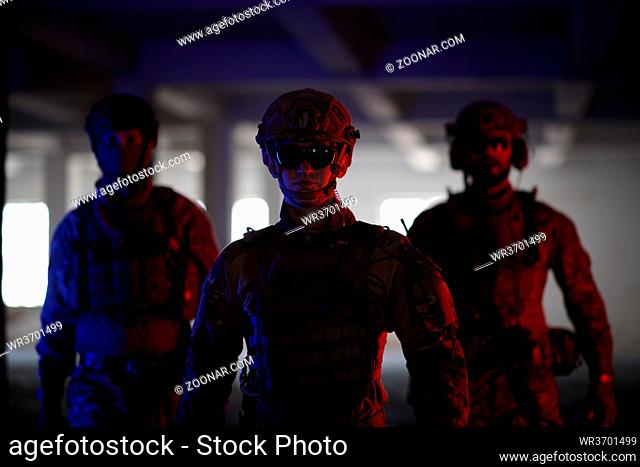 soldier squad team walking in urban environment colored neon lights