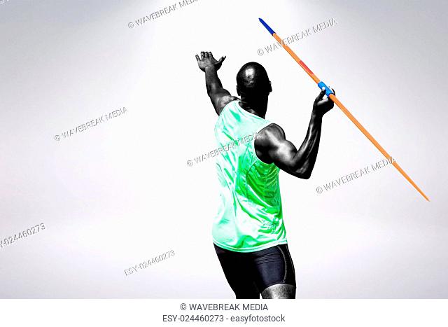 Composite image of rear view of man throwing javeline against white background