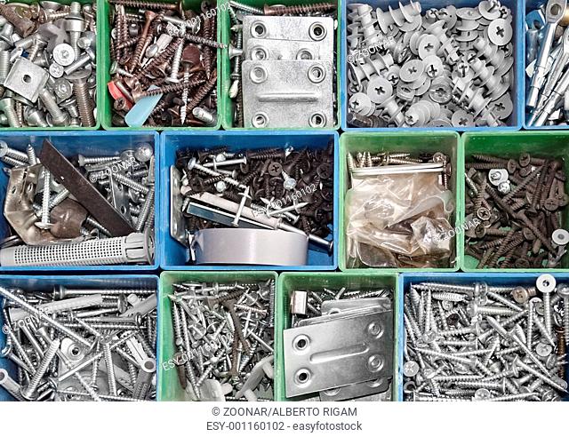 Toolbox full of metallic screws and consumable hardware