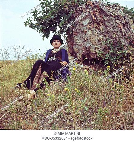 The singer Mia Martini (Domenica Rita Adriana Bertè) lying on the grass. Nice, France. 1971