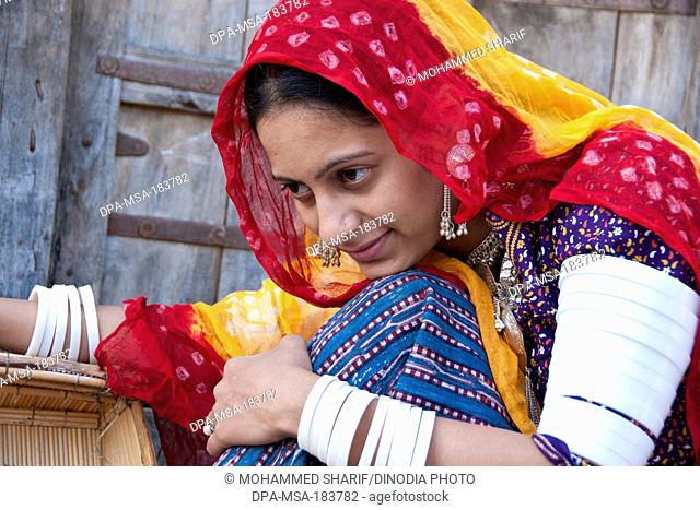 Rajasthani woman giving pose wearing traditional dress in front house jodhapur rajasthan India MR#786