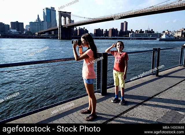 Dumbo/FULTON FERRY, New York City, NY, USA, 14 years old caucasian teenager girl and 12 years old caucasian teenager boy - both with brown hair and summer...