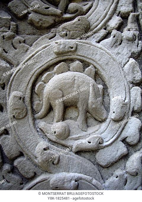 Stone carved reliefs of Stegosaurus at Angkor Ta Prohm temple in Cambodia