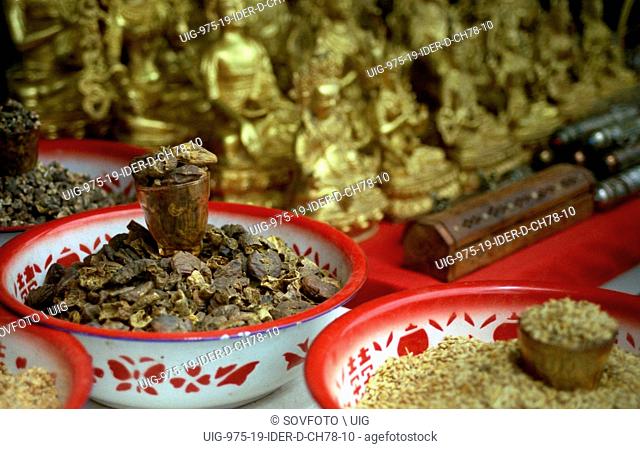 Still of traditional Tibetan herbs and small golden Buddha statues for sale on the Barkhor Circuit (kora), Lhasa, Tibet, China, August 2004