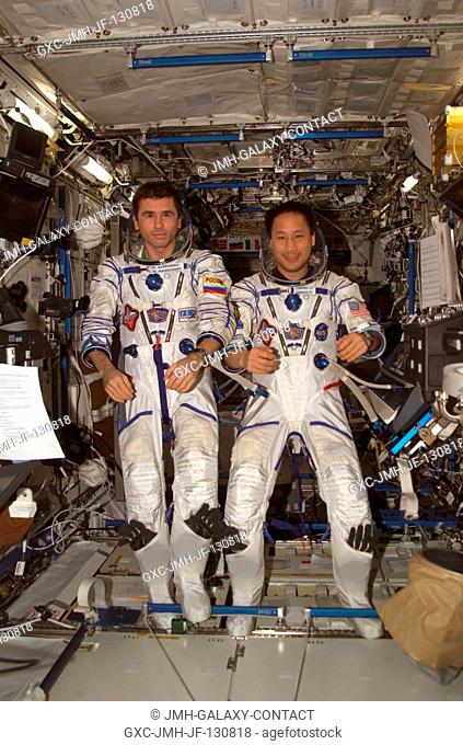 The Expedition 7 crew members, wearing Russian Sokol suits, pose for a crew photo in the Destiny laboratory on the International Space Station (ISS)