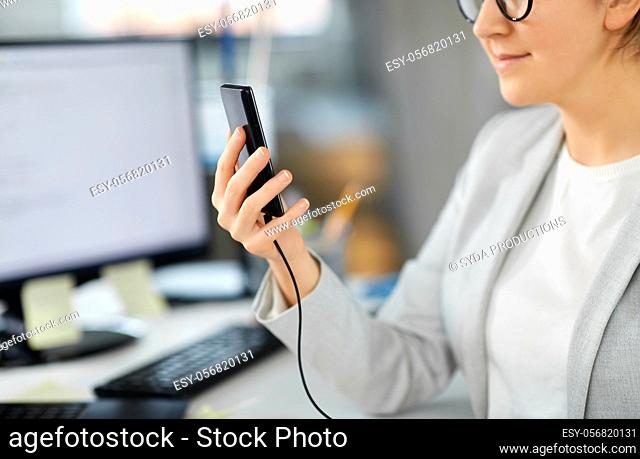 businesswoman with smartphone working at office