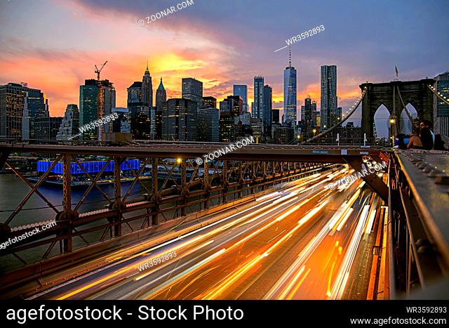 New York City / USA - JUL 10 2018: Lower Manhattan view from Brooklyn Bridge at sunset
