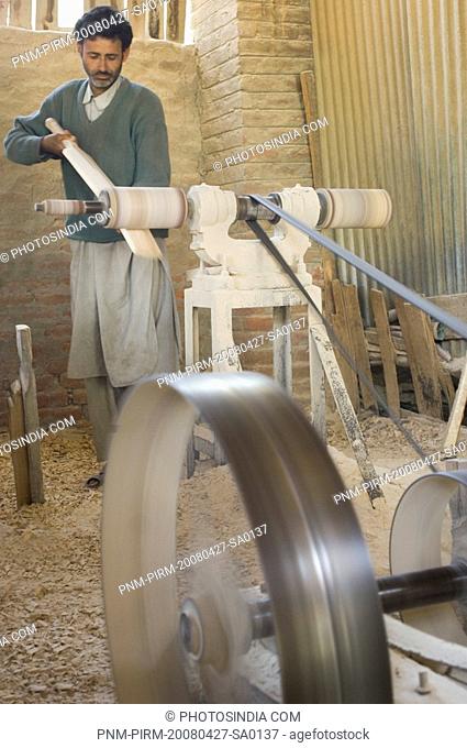 Carpenter making bat in a bat factory, Jammu And Kashmir, India