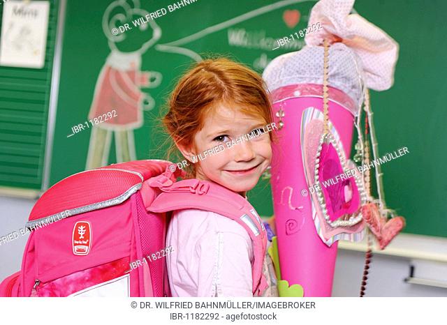 Girl on her first day at school holding a schultuete, school cone filled with sweets and gifts