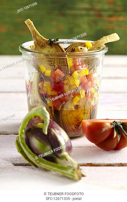 Young pickled artichokes with tomatoes, peppers, vinegar, oil, lemon, white wine and spices