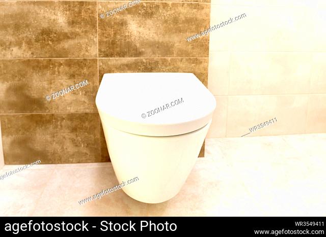 Close up of toilet bathroom interior with white ceramic seat