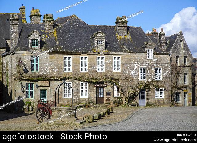 Village square with old horse-drawn cart and fountain, Locronan, named one of the most beautiful villages in France, Finistere department, Brittany region