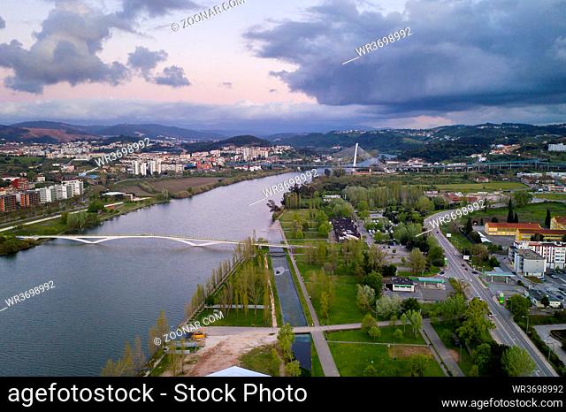 Coimbra drone aerial view of the city park, buildings and bridges at sunset, in Portugal
