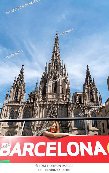 Woman on open top bus in front of Barcelona Cathedral, Barcelona, Catalonia, Spain, Europe