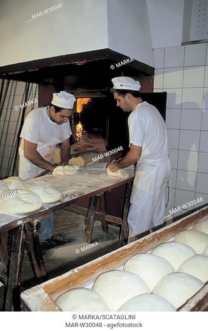 matera, two men prepare bread in 'cifarelli' bakery