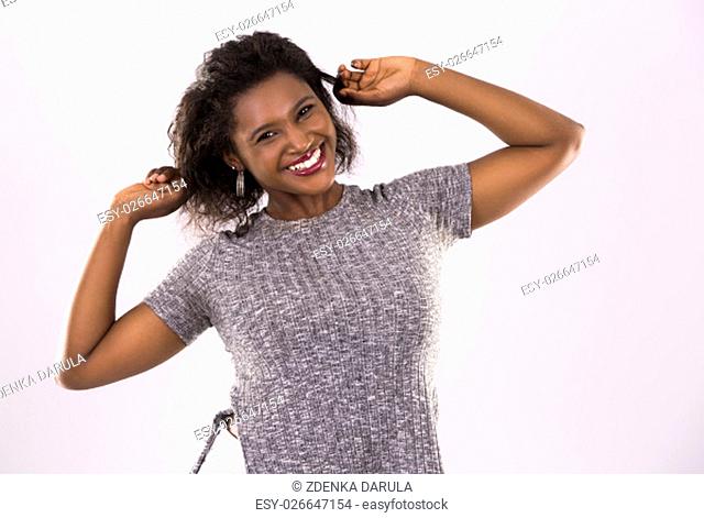 young black woman wearing casual outfit on light grey background