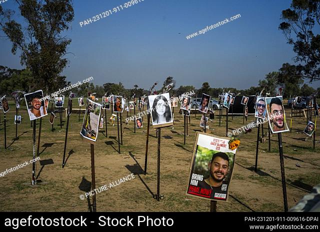 01 December 2023, Israel, Re'im: The images of the killed Israelis are seen at the site of the Re'im music festival massacre
