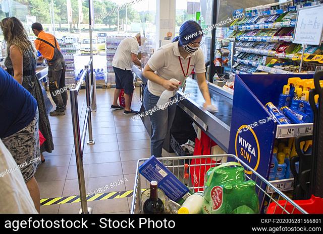 Spar shop cash desk, cashier wearing a face mask, a hand disinfection, sprayer disinfectant solution, shopping cart, trolley, supermarket, Sukosan, Croatia