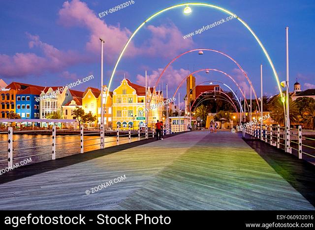 Curacao Willemstad March 2021, sunset at the colorful city of Willemstad with people walking at the flooten bridge