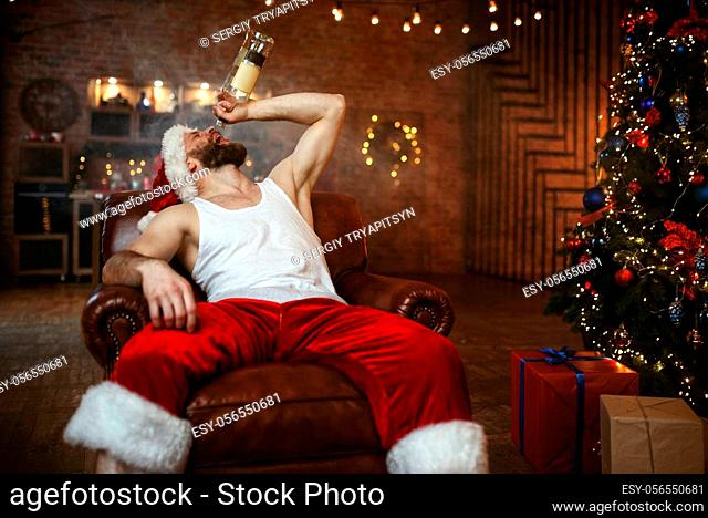 Bad Santa claus drinks alcohol, nasty party. Unhealthy lifestyle, bearded man in holiday costume, new year alcoholism