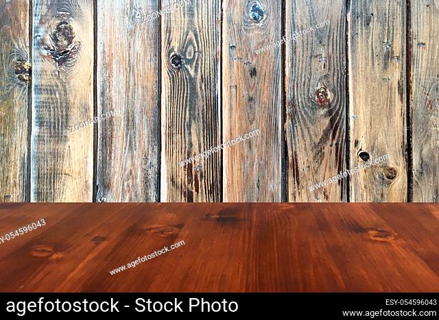old oak wood table on the brown wood wall background, wooden table