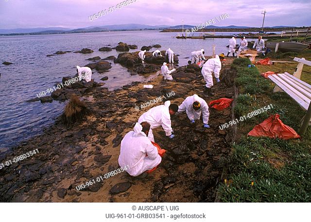 Cleaning oiled coastline after an oil spill, Bass Strait, Northern Tasmania, Australia. (Photo by: Auscape/UIG)