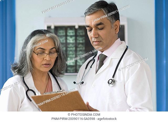 Female doctor discussing with a doctor, Gurgaon, Haryana, India
