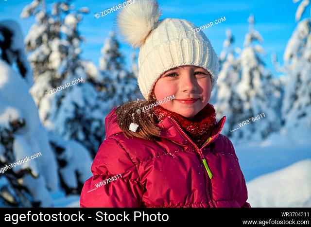 portrait of cute little girl on beautiful winter day with fresh snow