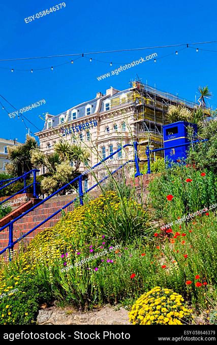 Eastbourne, United Kingdom - June, 01, 2017: Colorful flowers in front of the buildings along the seaside in Eastbourne, Sussex, United Kingdom