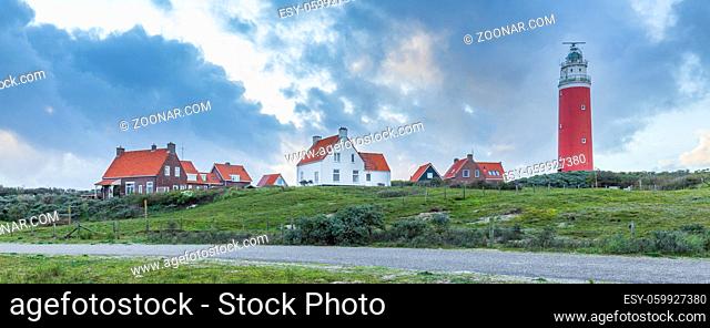 Landscape with scenic view of Lighthouse with rainy clouds at Waddenisland Texel, North Holland, Netherlands