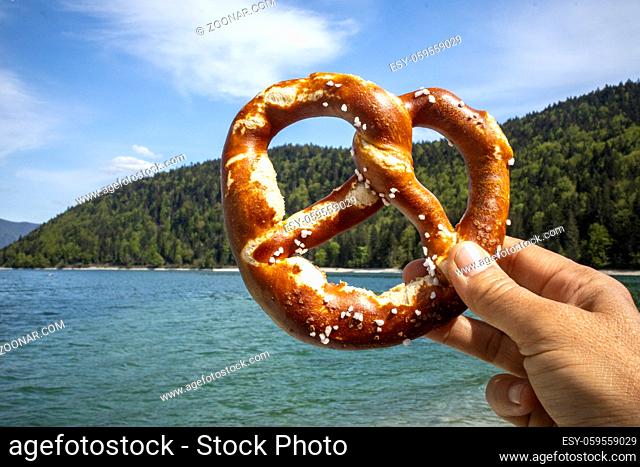 hand holding a pretzel at Walchensee