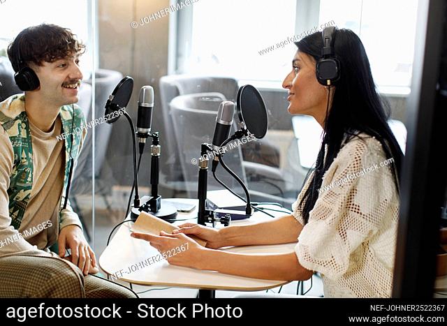Man and woman doing podcast in studio