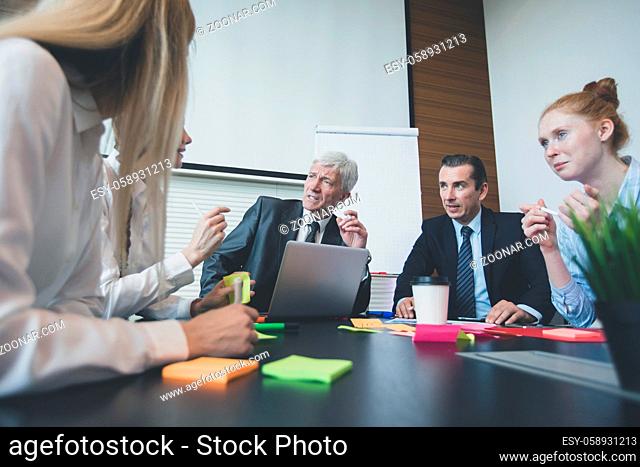 Working process at business meeting , people sitting around office table discussing ideas