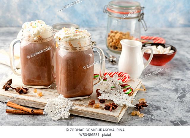 Hot chocolate with whipped cream in mason jar and marshmallows