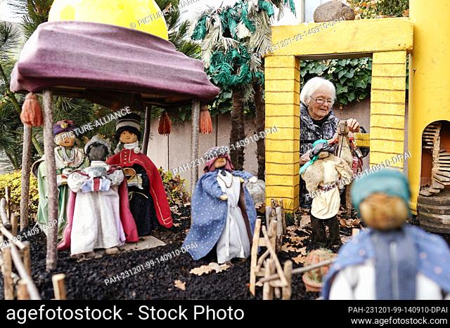 30 November 2023, Rhineland-Palatinate, Bornheim: Ulla Kaub, initiator of the ""Nativity Village"", builds a nativity scene