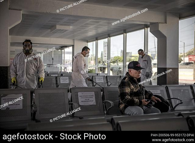 02 May 2020, Mexico, Tijuana: Members of the group ""Covid Busters"" carry out disinfection measures against the spread of Covid-19 at a bus station