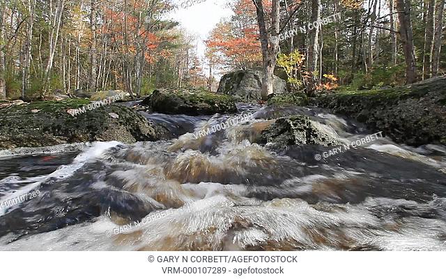 water flowing in a small stream in the Adirondack mountains in New York state USA in autumn