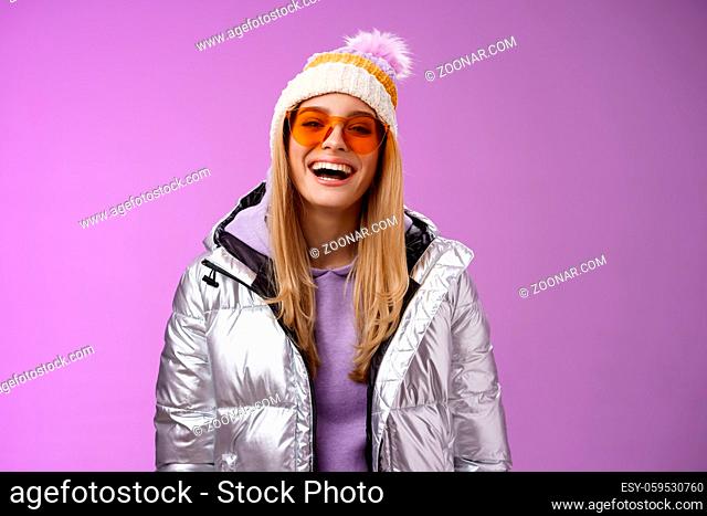 Stylish friendly charismatic blond woman in silver shiny jacket hat sunglasses ready learn snowboarding smiling laughing happily having fun snowy recreation...