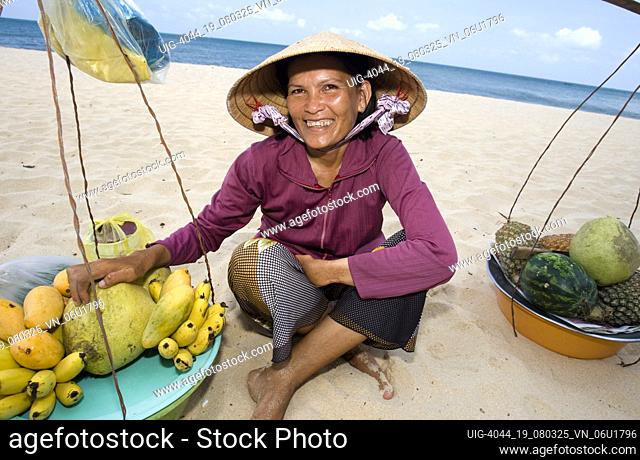 Conical hat woman tropical fruit vendor Long Beach Phu Quoc Island Vietnam