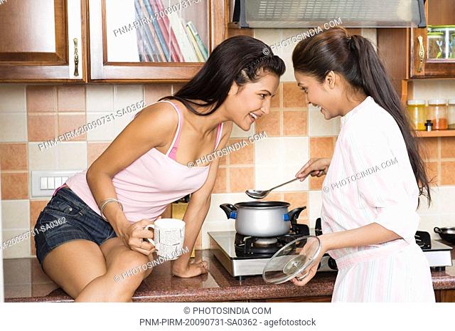Lesbian couple cooking in the kitchen