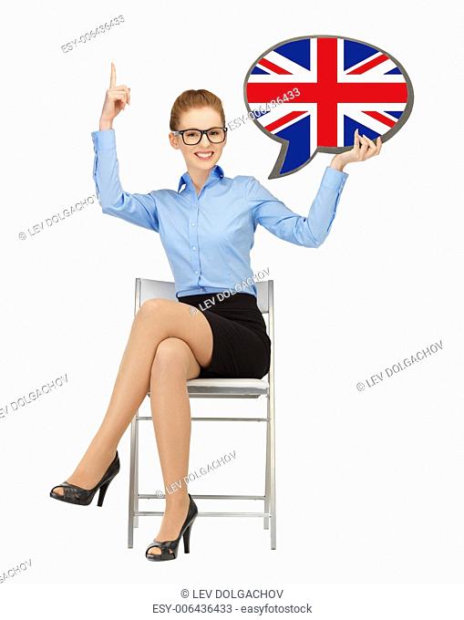 education, foreign language, english, people and communication concept - smiling woman holding text bubble of british flag and pointing finger up