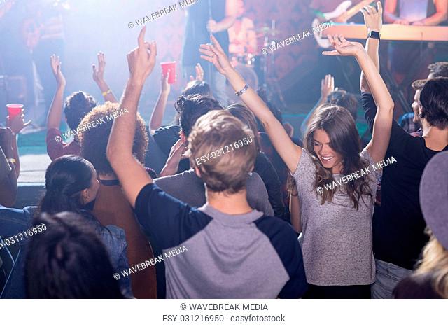 Cheerful fans dancing in nightclub