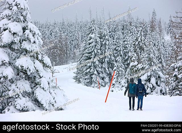 PRODUCTION - 01 February 2023, Saxony-Anhalt, Schierke: Hikers are on their way to the Brocken. Strong storms with snow and freezing rain again prevented the...