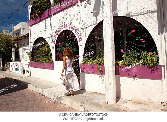 Woman walking in the street of town center, Isla Mujeres, Quintana Roo, Yucatan Province, Mexico, Central America