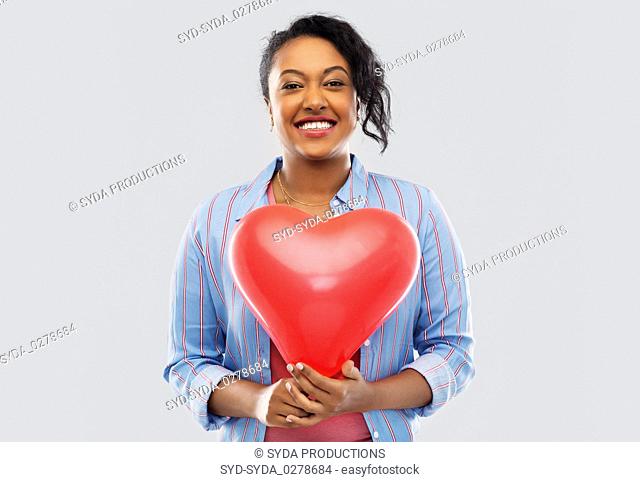 african american woman with heart-shaped balloon