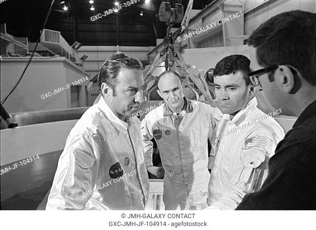 The three prime crewmen of the Apollo 13 lunar landing mission stand by to participate in water egress training in a water tank in Building 260 at the Manned...