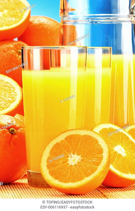 Composition with glasses of orange juice and fruits