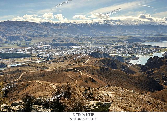 View to outskirts of Cromwell over man-made Lake Dunstan and gold-mining excavations beyond, Otago, South Island, New Zealand, Pacific