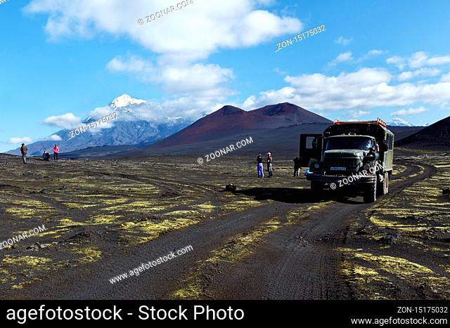 TOLBACHIK VOLCANO, KAMCHATKA PENINSULA, RUSSIA - AUG 27, 2014: Russian extreme off-road expedition truck ZIL-131 (6-wheel drive) on mountain road on background...