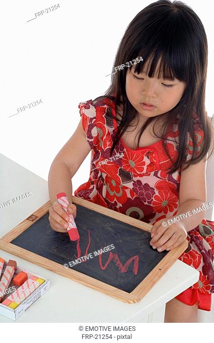 Girl drawing on blackboard
